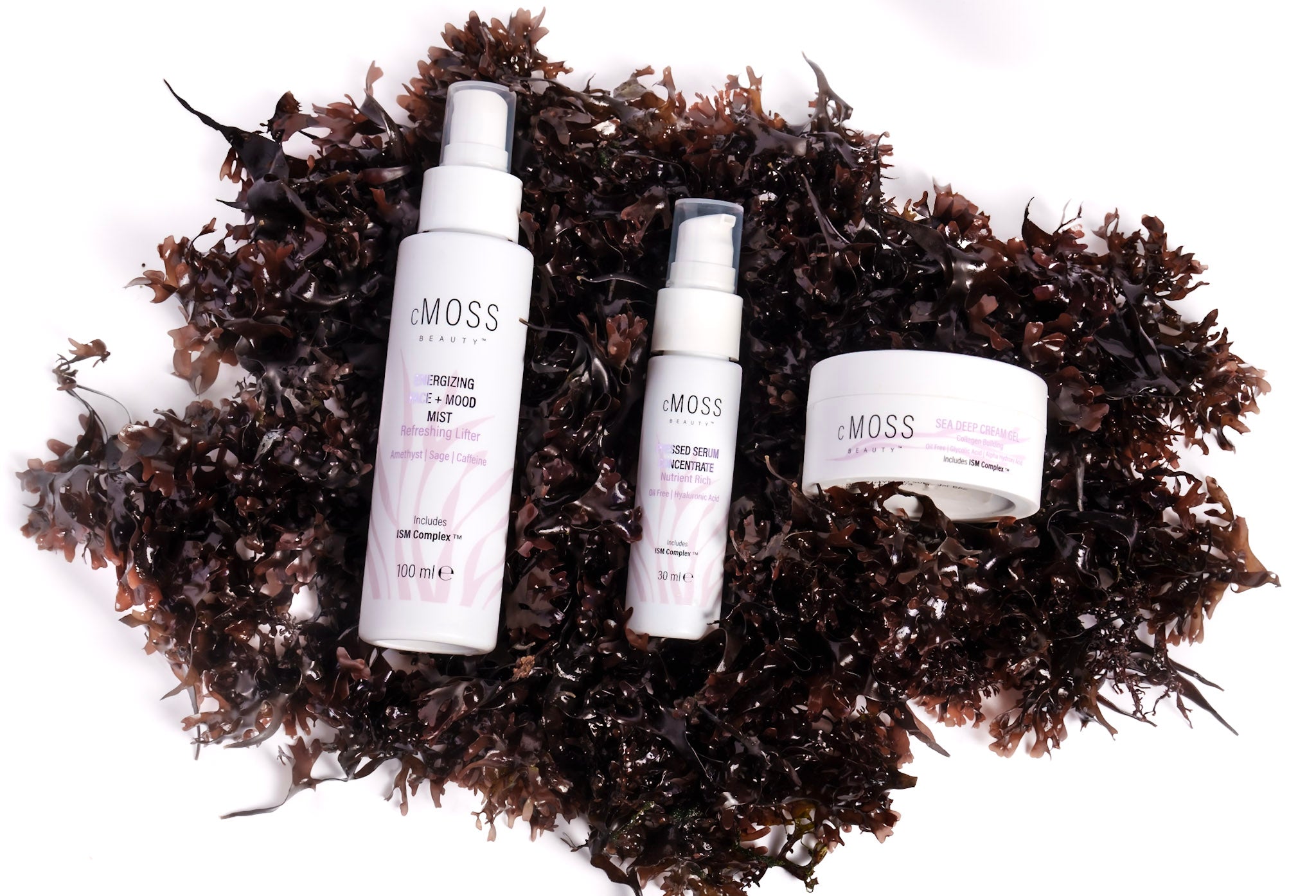 cmoss energizing face and mood mist, pressed serum concentrate and sea deep cream gel over bed of irish sea moss