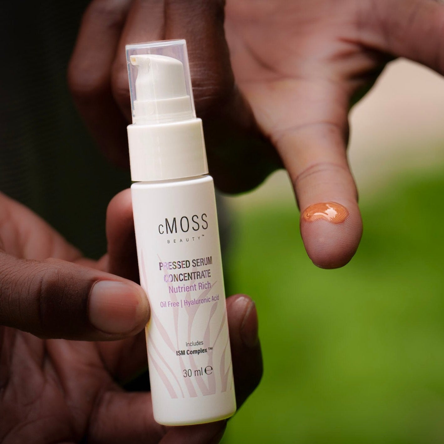 cmoss pressed serum concentrate on finger