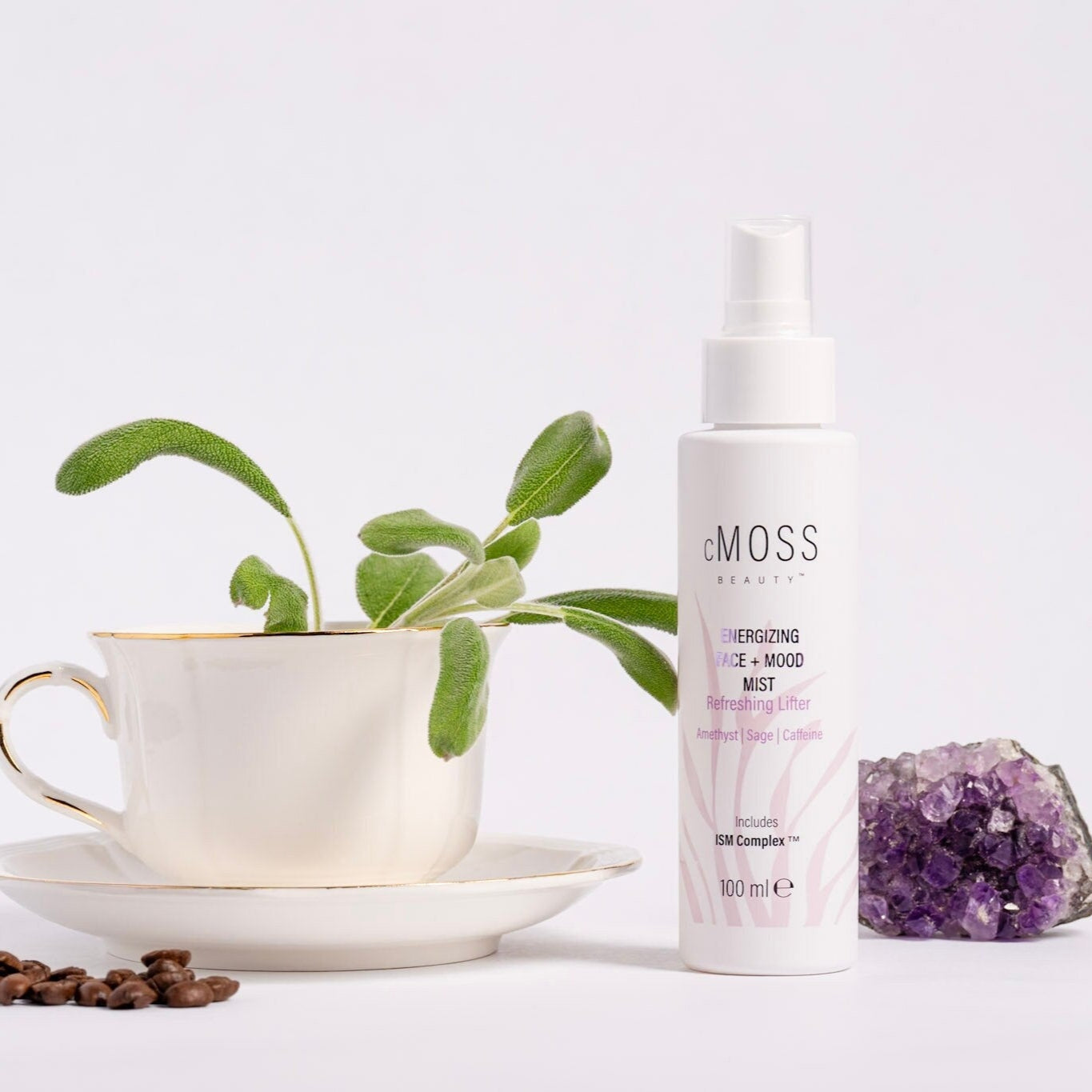 cmoss energizing face and mood mist next to amethyst tea cup and coffee beans