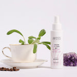 cmoss energizing face and mood mist next to amethyst tea cup and coffee beans